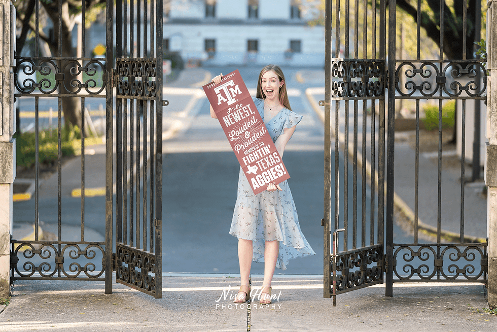 College-bound senior holding a Texas A&M Aggie banner with a bright smile, showing dimple and blue eyes in an elegant portrait.