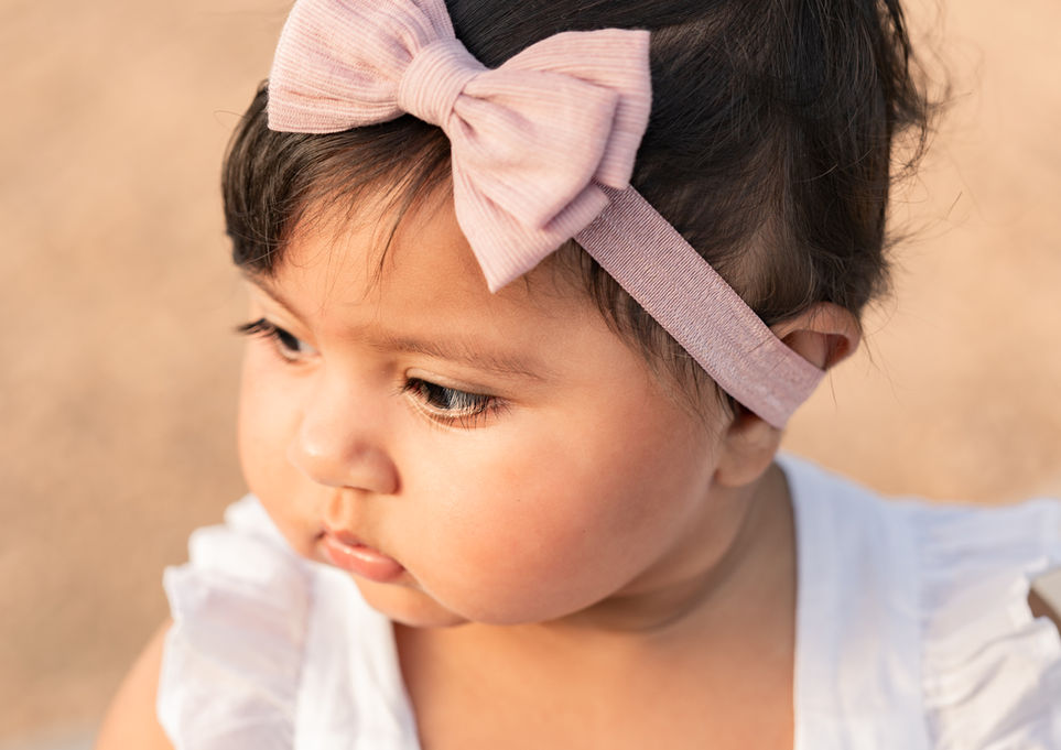 Young toddler exploring nature during family photo session in Dripping Springs with natural candid photography.
