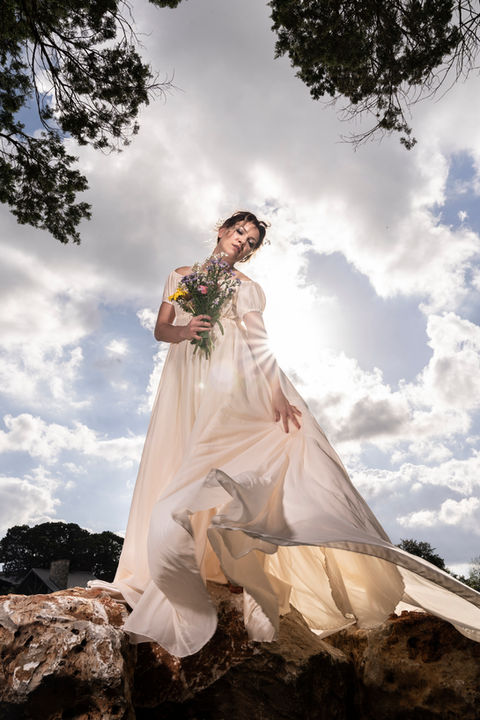 Bride dramatic sun bursting through gown on wedding day