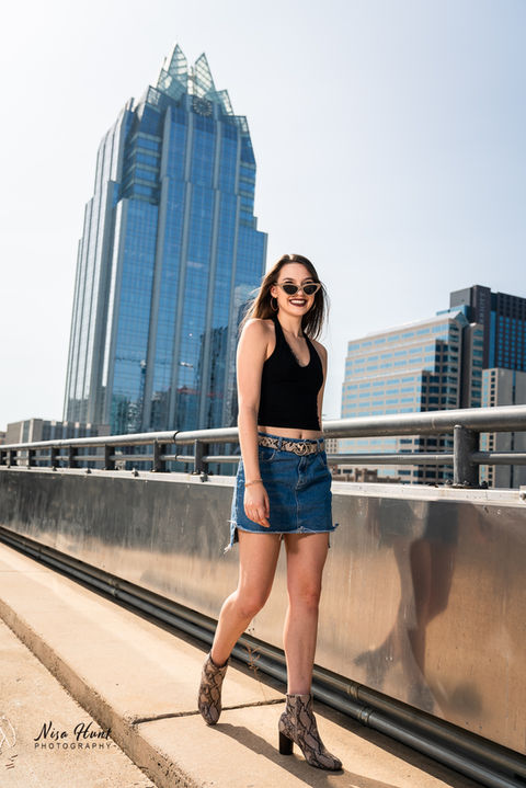 Senior girl rooftop session in Austin with skyline view and urban fashion styling