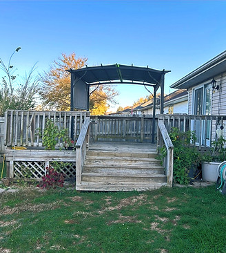 A twenty year old deck that was torn down and replaced with a Newly stained red cedar deck with custom benches and planters