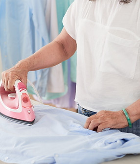 side-view-female-mid-section-ironing-shirt-home.jpg