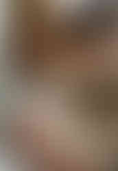 Newborn Photography Hertfordshire - A photo of a couple, holding their newborn sleeping baby