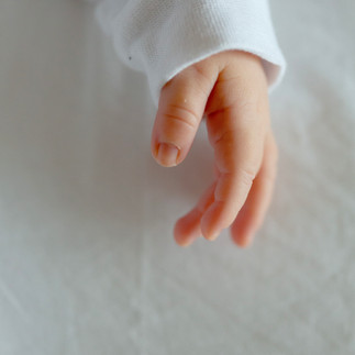 Newborn Photography Hertfordshire - Baby hand on a white sheet