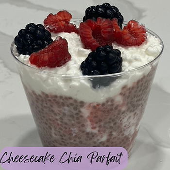 Cheesecake chia parfait in clear cup with raspberries, blackberries, and creamy topping. Text "Cheesecake Chia Parfait" in purple banner.