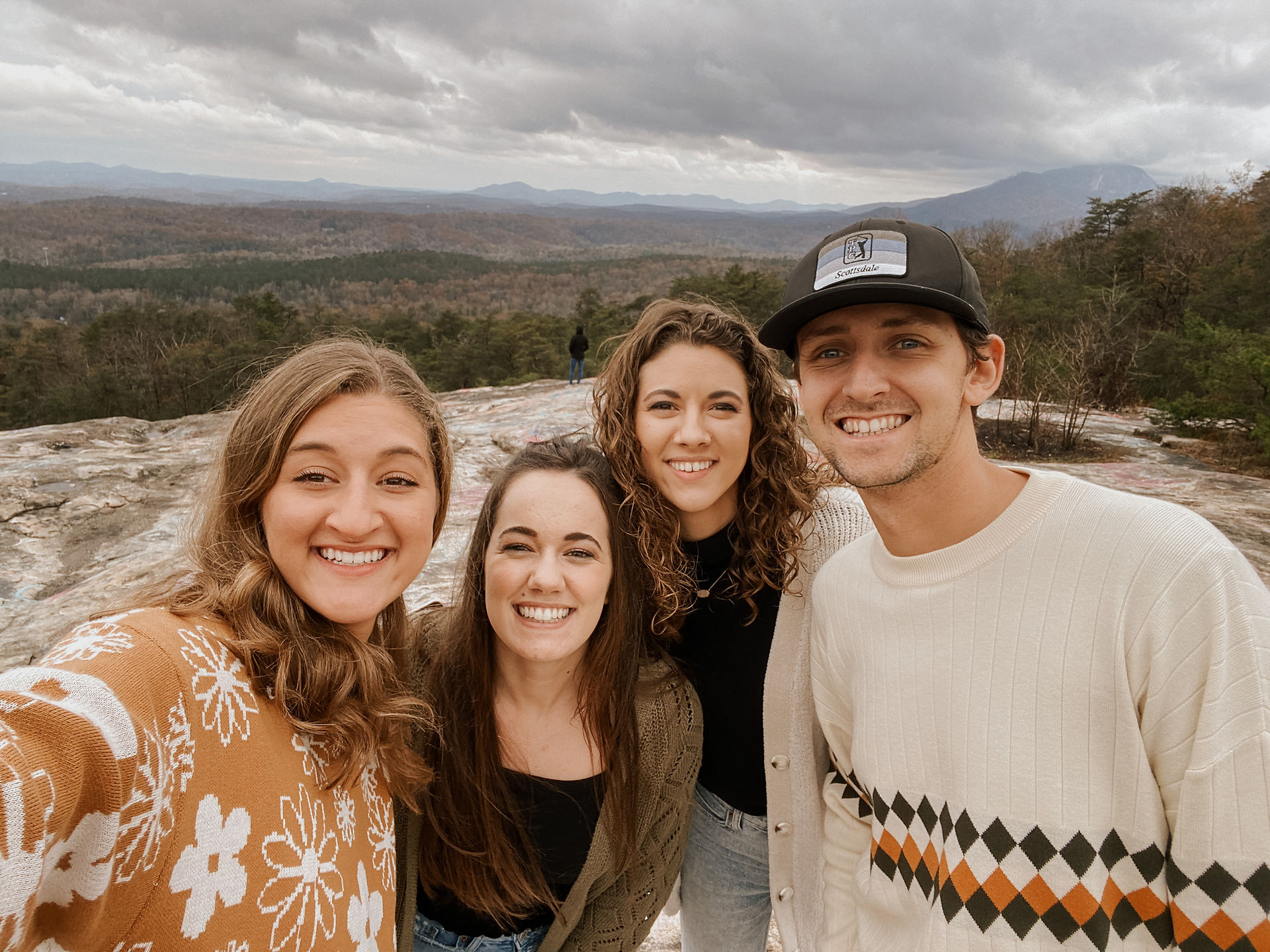 four friends taking a selfie on a hike