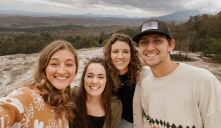 four friends taking a selfie on a hike