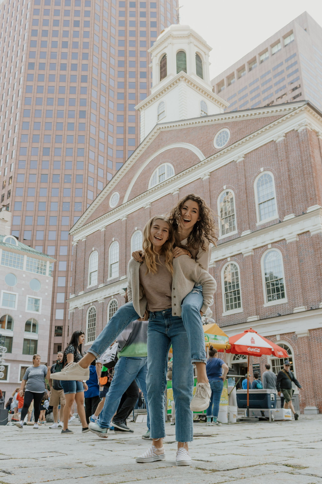 sisters in boston giving a piggyback ride