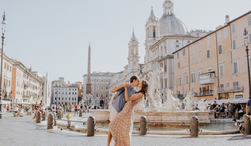 couple in front of a fountain in italy