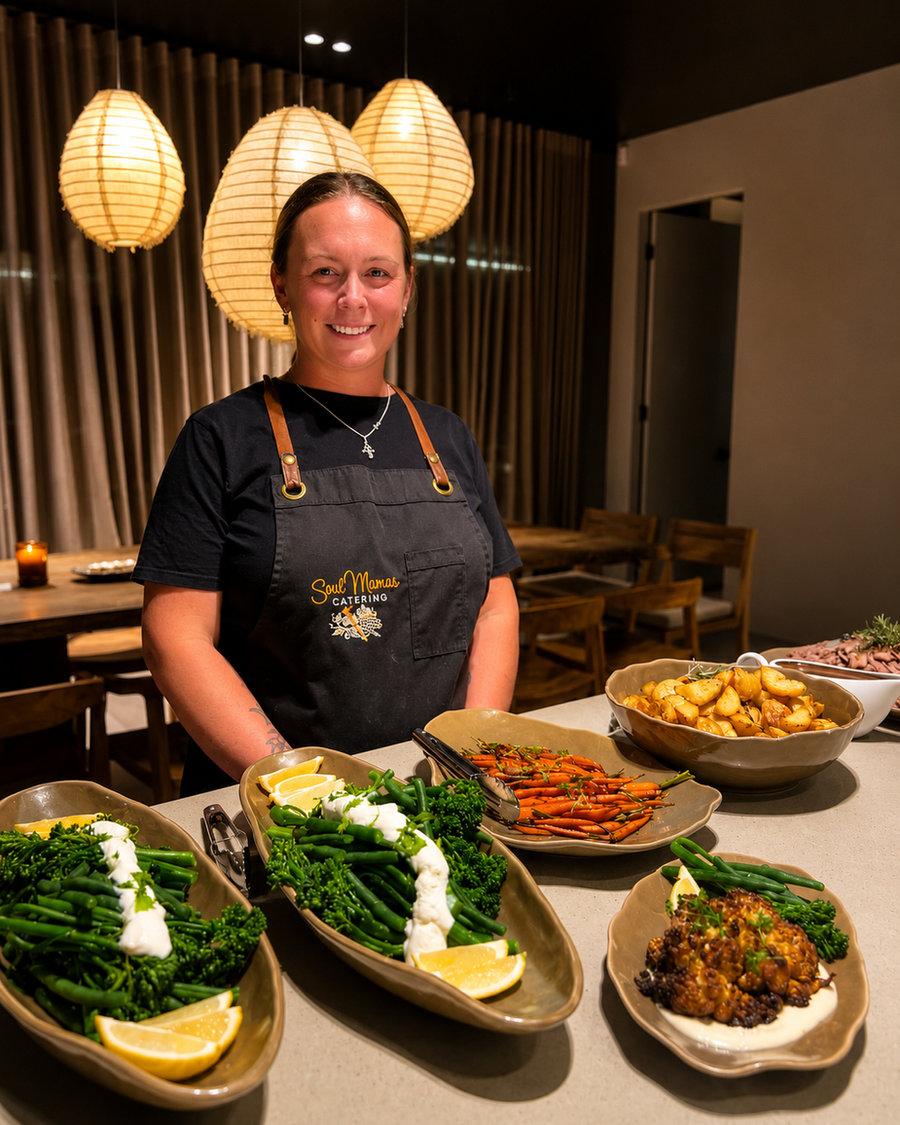 Jessmyn Toovey in a Soul Mamas apron behind a table of roast vegetables