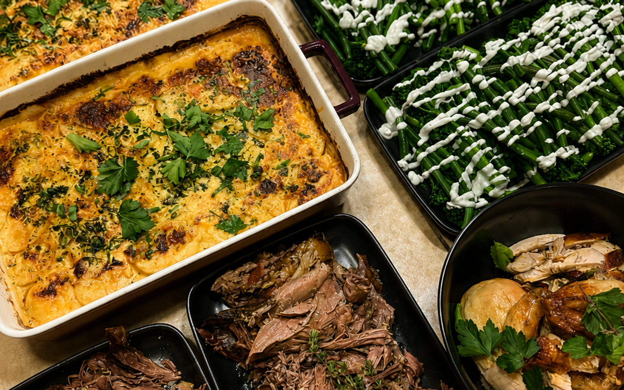 Trays of potato bake, greens, slow-cooked meat and roast chicken ready to serve