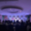The photo captures a moment from a stand-up comedy show in Kota, where Alok Gautam is on stage, delivering his hilarious set to a room full of entertained and giggling audience members. The room is buzzing with laughter as Alok’s witty jokes and perfect timing have the crowd in stitches. The audience, a mix of young and old, can be seen laughing heartily, some with wide smiles and others with their hands covering their faces in disbelief at the humor. Alok stands confidently at the center of the stage, his expressive gestures adding to the energy of the room. The intimate atmosphere at the venue makes it clear that everyone is having a fantastic time, united by the infectious joy of live comedy. The room is alive with a sense of excitement and amusement, making it a memorable evening of entertainment.