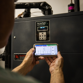 Person servicing a heat pump.