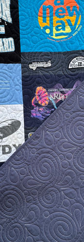 T-shirt quilt with 'MEOWDY' and 'New Day' squares, blue patterned backing.