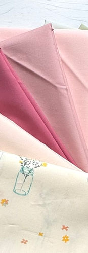 Solid pink and green fabrics with patterned floral fabric