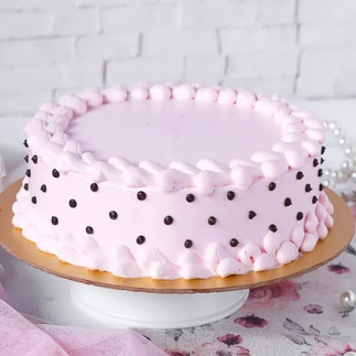 Image of cake white in colour with black dots on it