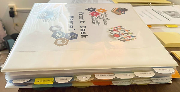 Side view of the binder/manual. View of the many tabs.