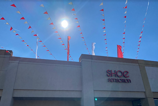 Advertising flags above a building for a grand opening