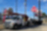 Bucket truck with a trailer backed up to an arbys sign for install