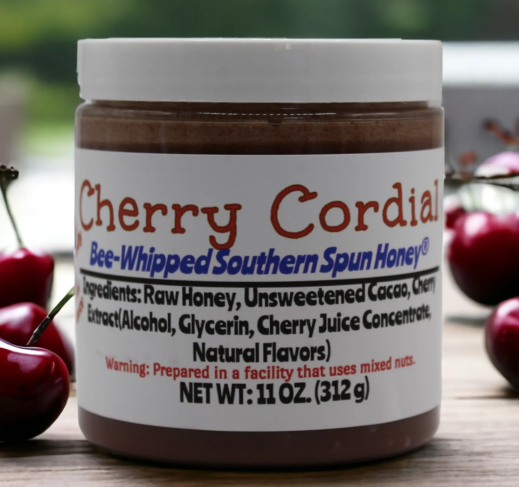 Cherry Cordial Bee-Whipped Southern Spun Honey. 11 oz. jar front view.