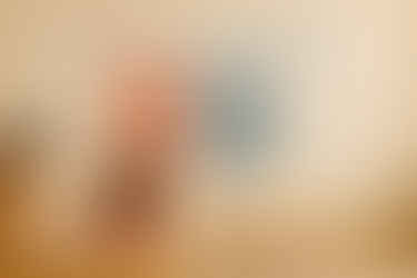 A child and an adult read together at a table in a classroom. Behind them is a large wall chart titled ‘Sight Words vs. High-Frequency Words,’ with a red and blue Venn diagram showing sight words, high-frequency words, and shared words such as ‘the,’ ‘you,’ and ‘we.’ Additional word cards like ‘was,’ ‘said,’ ‘want,’ ‘and,’ ‘that,’ and ‘with’ are arranged around the chart.