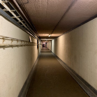 The entrance tunnel of the secret bunker stretching away into the distance