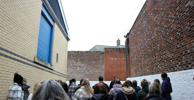 A man talking to a tour group in Dorchester Prison