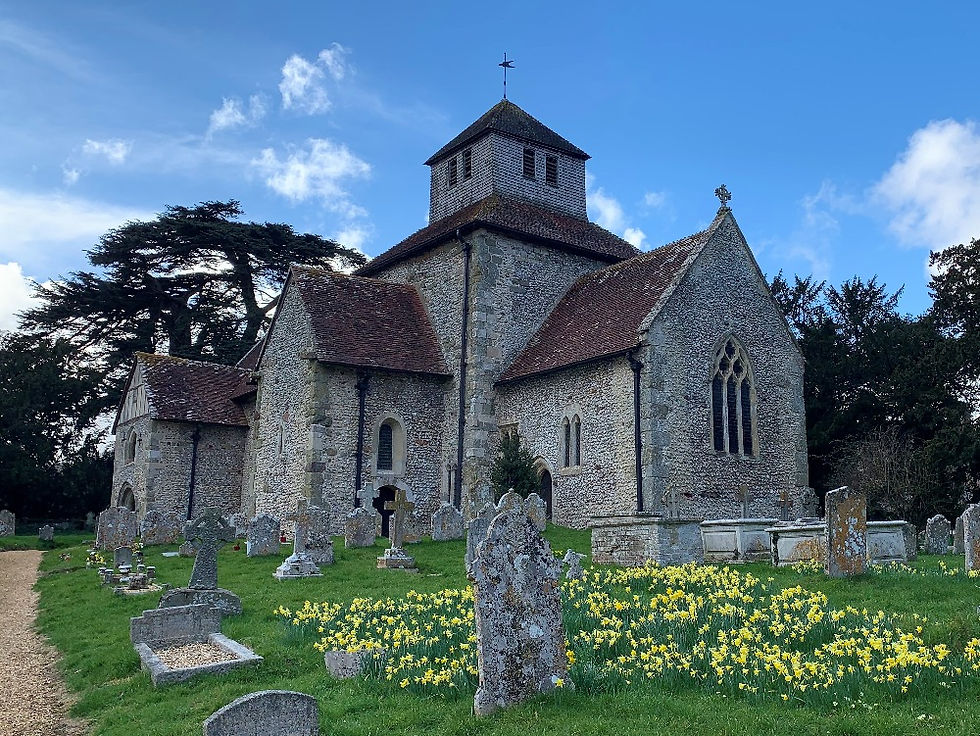 The exterior of St Mary Breamore with daffodils in the foreground