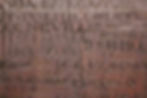 A close up of the names engraved into the panelling, often on top of previous names