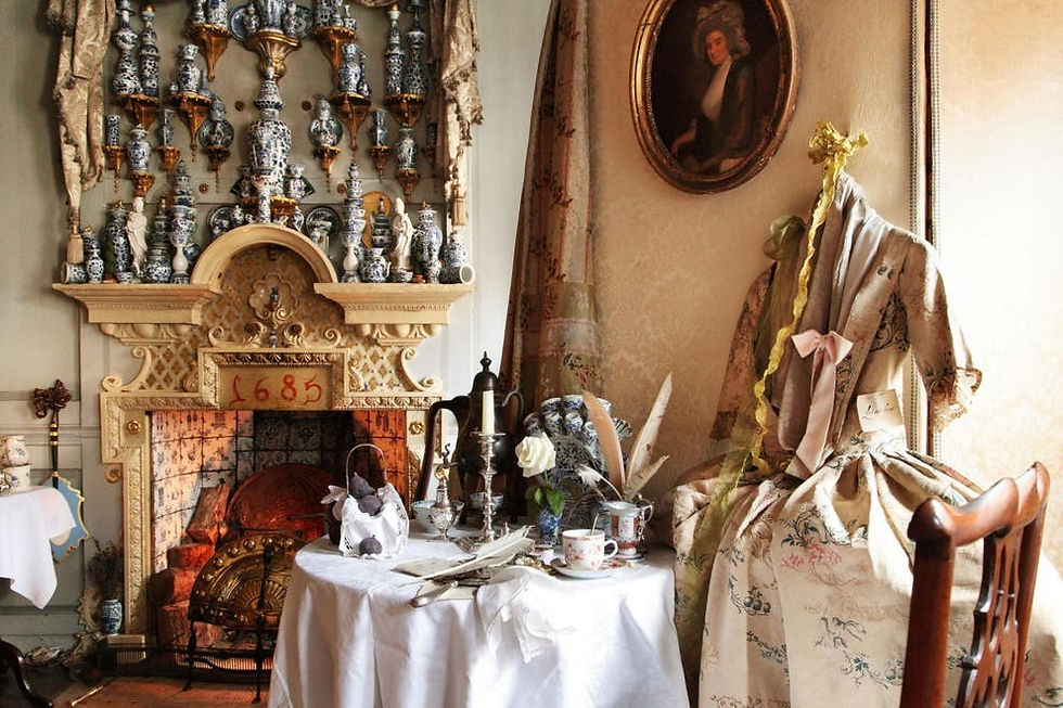 An old fireplace and ceramic display as well as a Georgian dress.