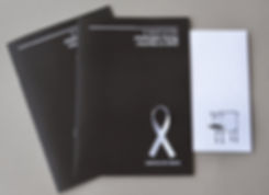 Photograph of charity report featuring white ribbon