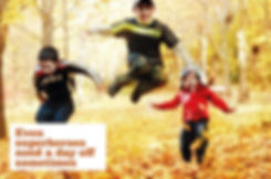 Superhero concept showing three yong children jumping in autumn leaves