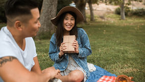 Happy couple having a date by going on a picnic.