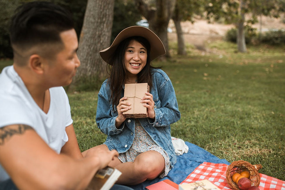 Happy couple having a date by going on a picnic.
