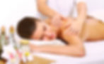 High angle view of massage therapist working on client's leg muscles