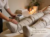 The person is wearing a pressotherapy suit