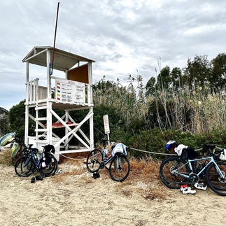 lifeguard tower on sandy beach with bikes lined up in front