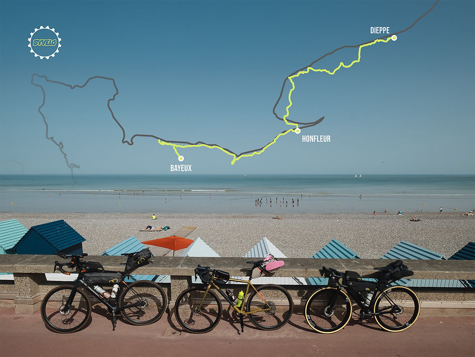 Three loaded road bikes on a seaside promenade, with a beach and map overlay showing Bayeux, Honfleur and Dieppe routes.