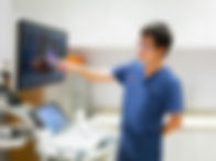 Dr. Woo Jia Wei reviewing an echocardiogram at Sunrise Heart Specialist Clinic, highlighting advanced cardiac diagnostics and personalized care in Singapore.