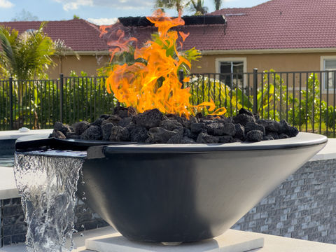 A fire-water bowl, elevated on a pedestal, pouring into a pool below.