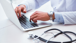 Doctor looking at laptop