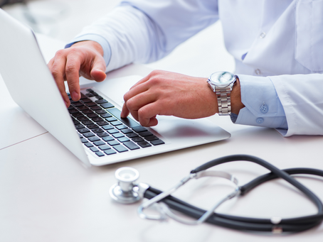 Doctor looking at laptop