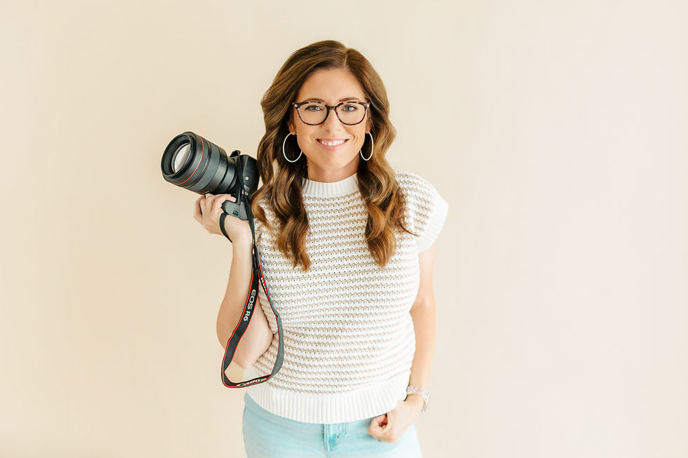 Christie Gare, family photographer based in Frisco Tx, holding a camera