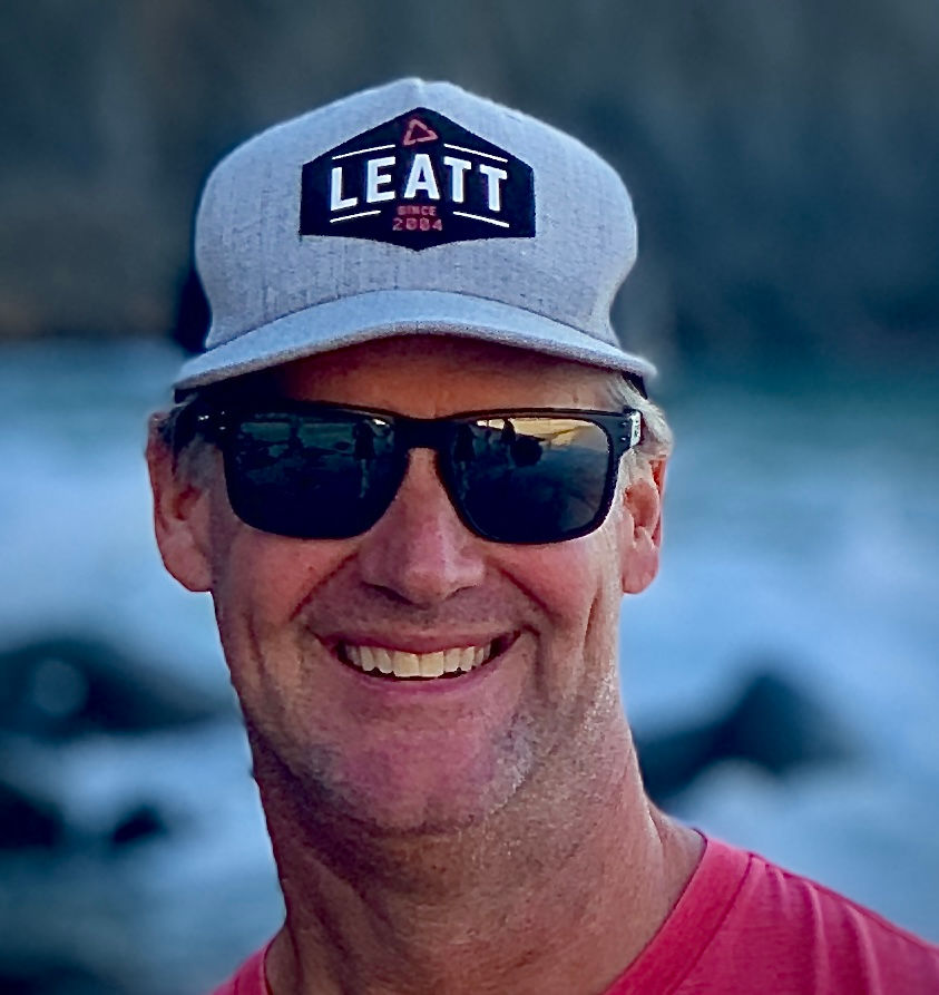 Smiling man wearing a Leatt hat outdoors, pool service expert