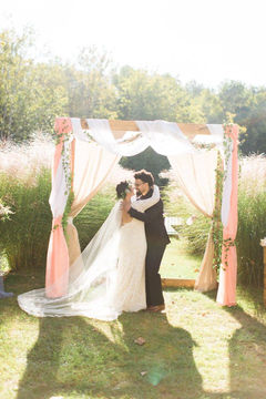 Wooden Arch Draped with Fabric and Flowers