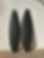 Pair of black hand-carved surfboards with palm tree designs