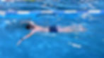 boy swimming breaststroke on the surface and under water,
chapec plavajuci techniku prsia nad a pod vodou
