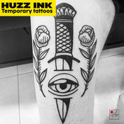 Dagger through eye tattoo design by Huzz Ink tattoo shop in Dubai