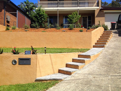Blue Mountains Rendered retaining wall with steps going up a steep concrete driveway