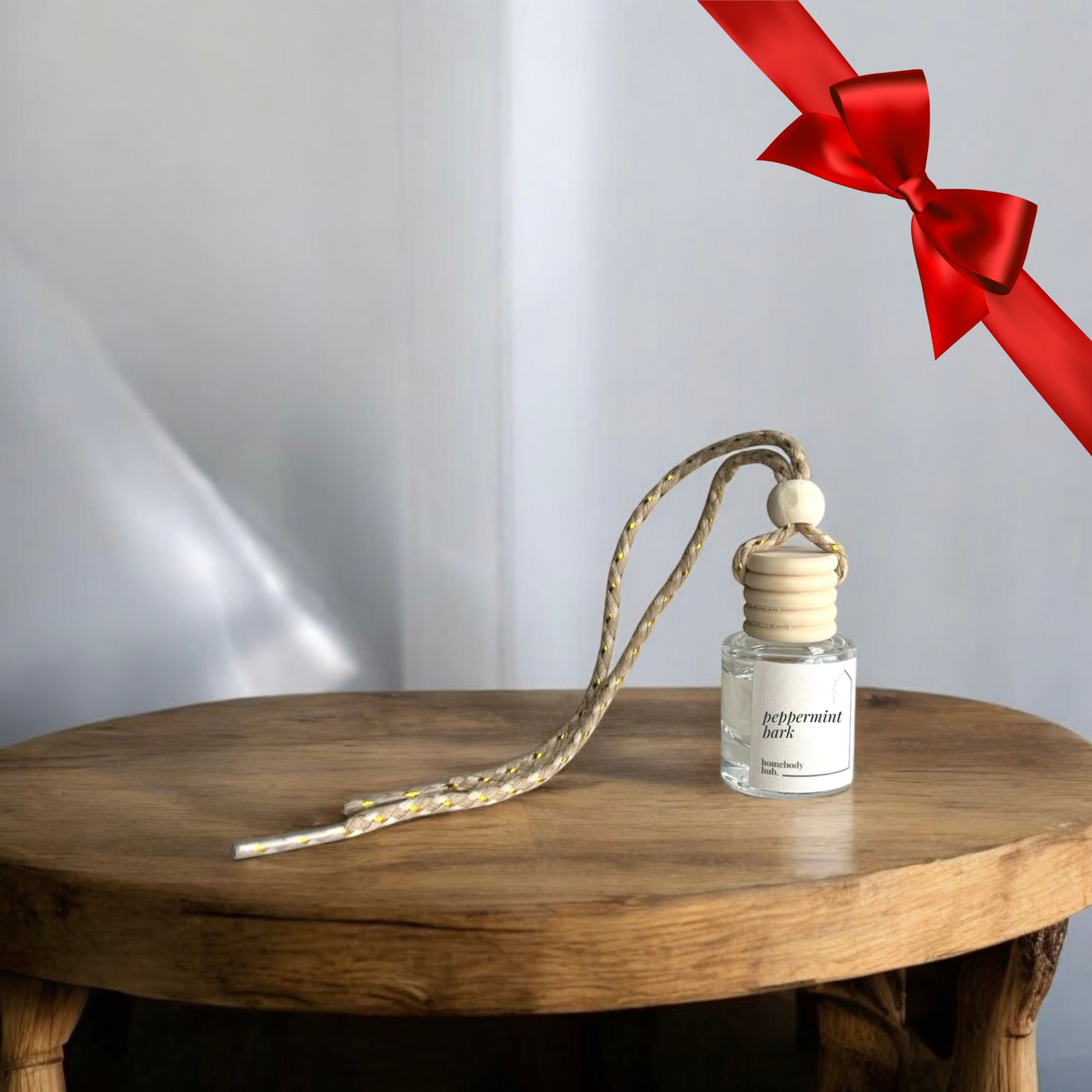 peppermint bark car diffuser sitting on a wooden table.